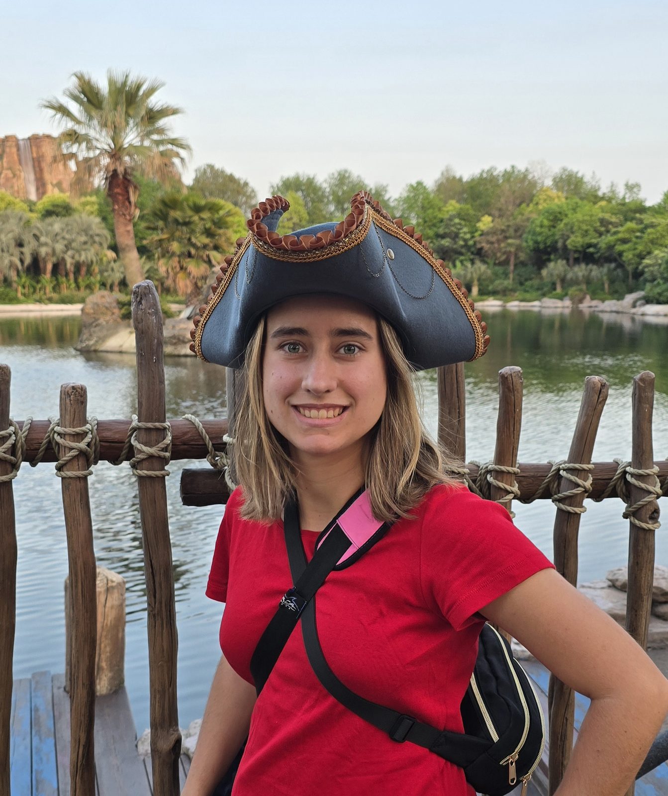 Lisa in a pirate hat by the lagoon