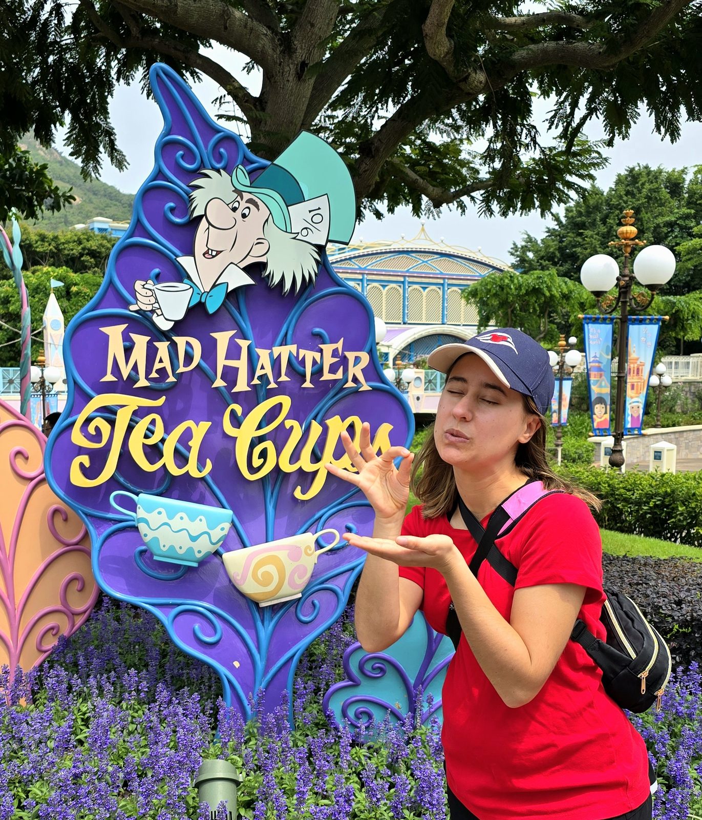 Lisa at the Mad Hatter Tea Cups sign