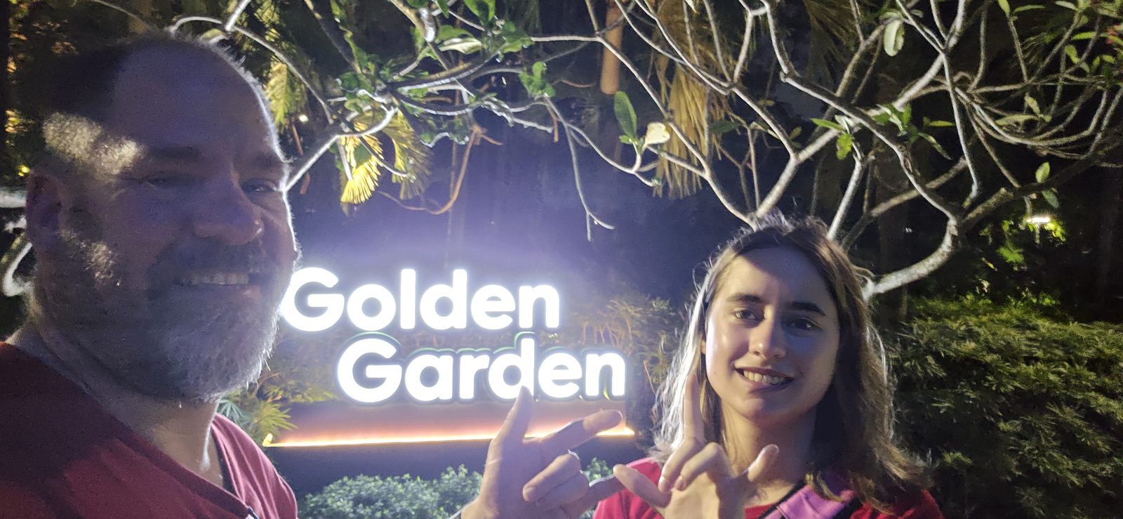 Laughing under the Golden Garden sign