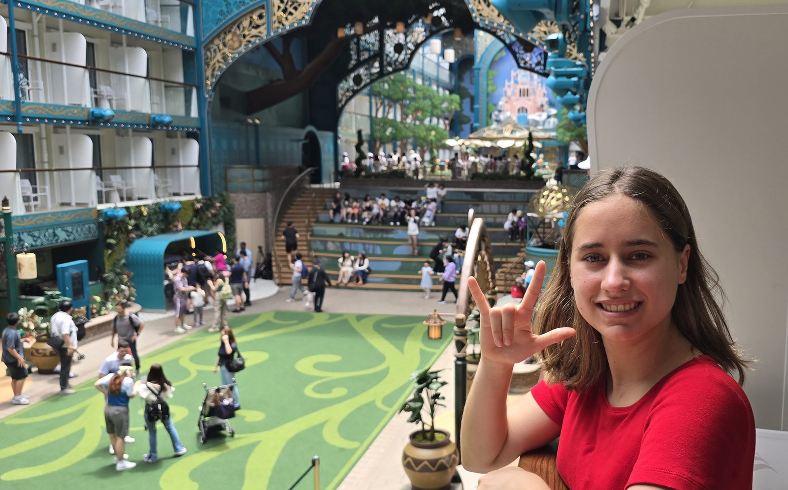 Lisa signs I love you in the ship's atrium