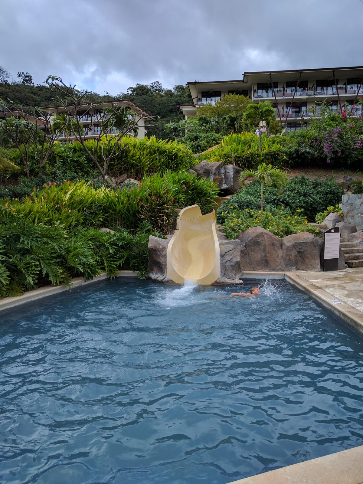 The resort pool and slide at Dreams Las Mareas