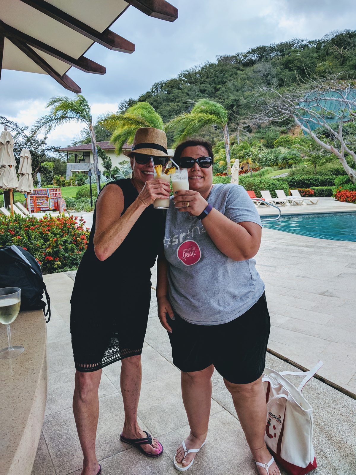 Kathy and a friend toast by the pool