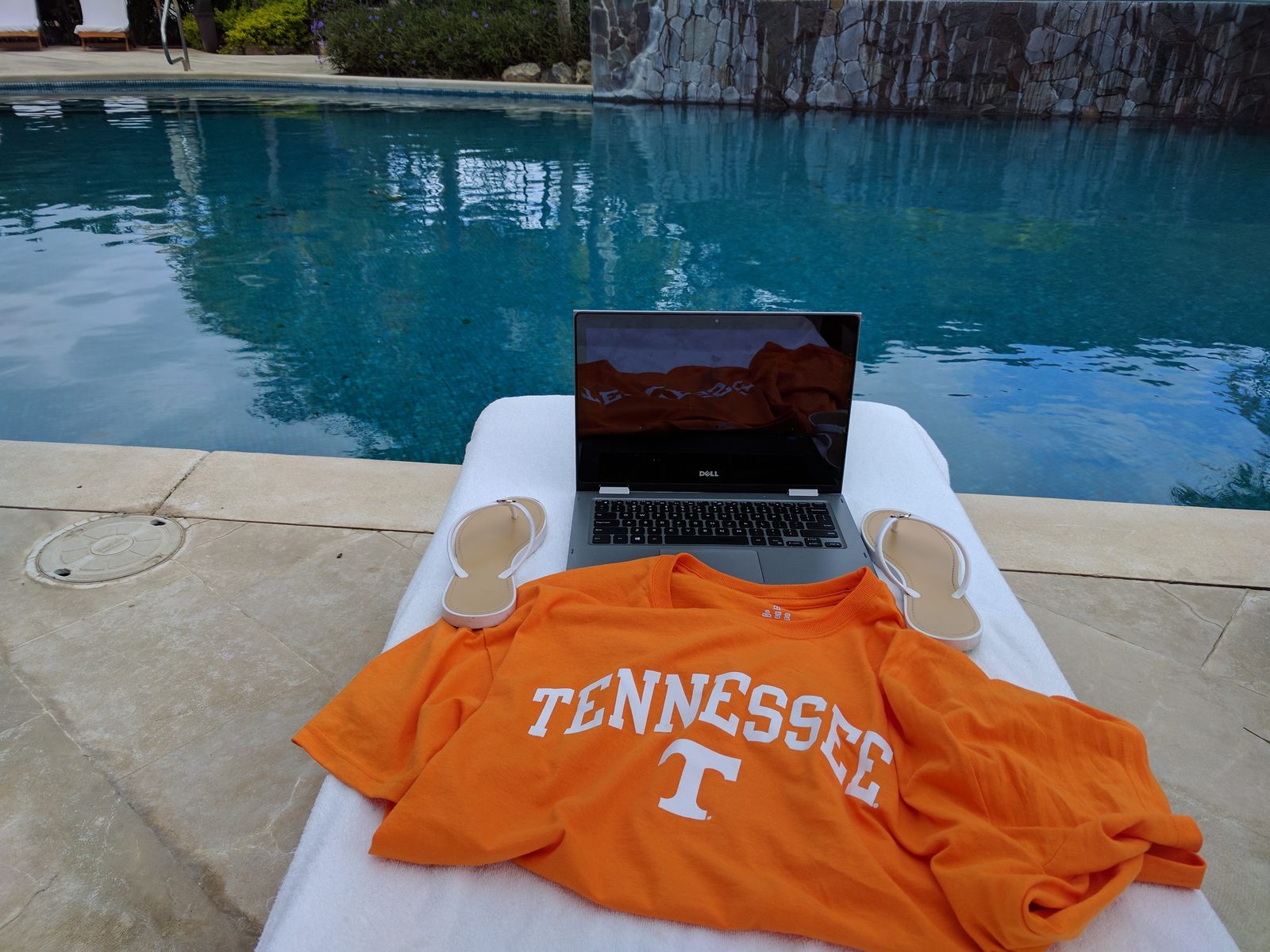 Laptop and her Tennessee shirt by the pool