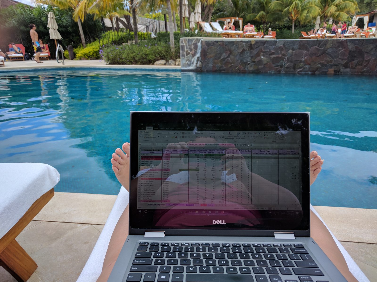 Kathy works by the pool between sessions