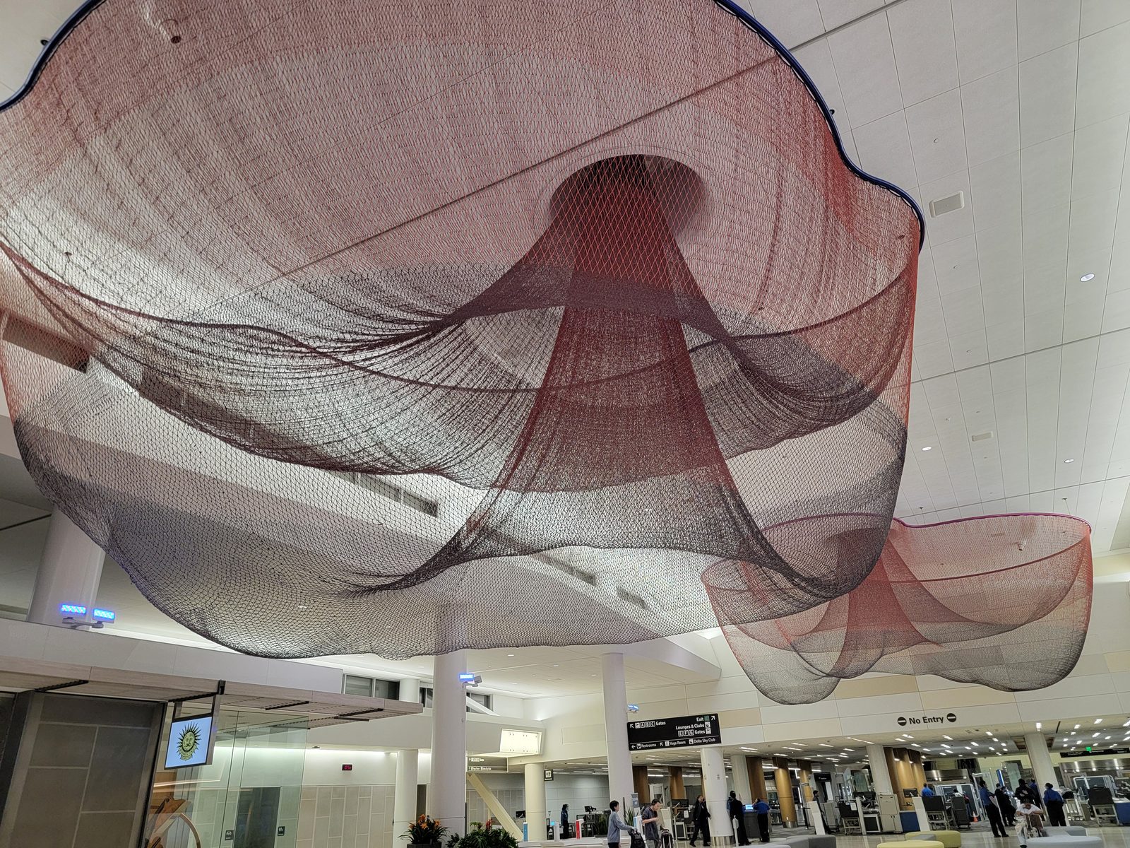 A giant net sculpture hanging over the SFO terminal