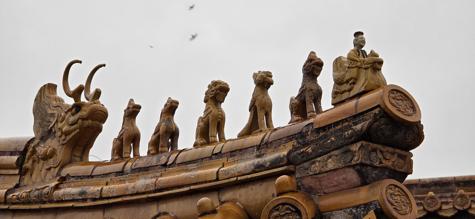 The little beasts along a Forbidden City roof ridge