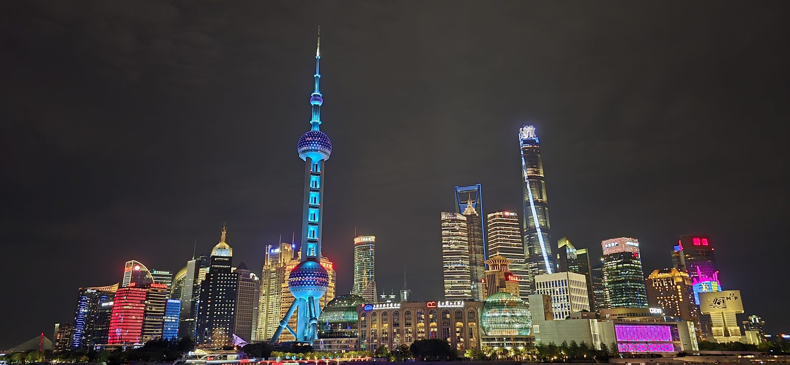 Pudong glowing blue and pink across the river